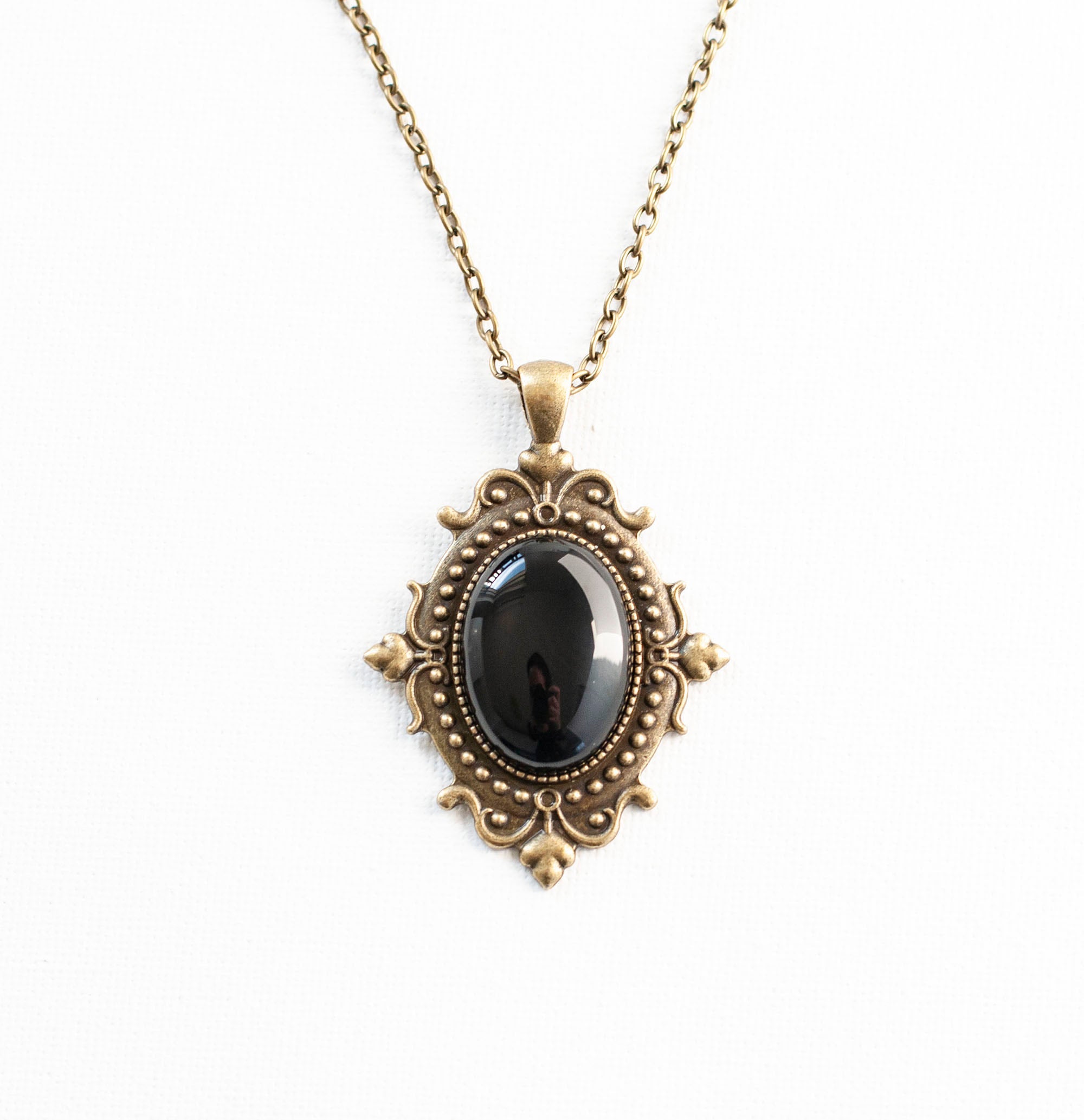 Black Onyx cameo pendant necklace with bronze filigree